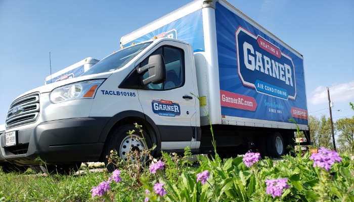 Garner installation truck in front of flowers