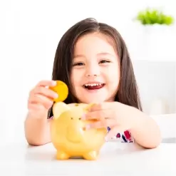 Happy Girl With Piggy Bank